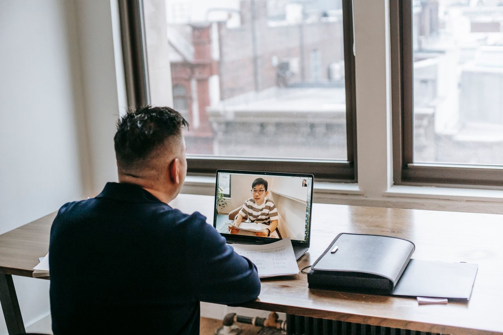 A tutor and student reviewing notes together over a live video call